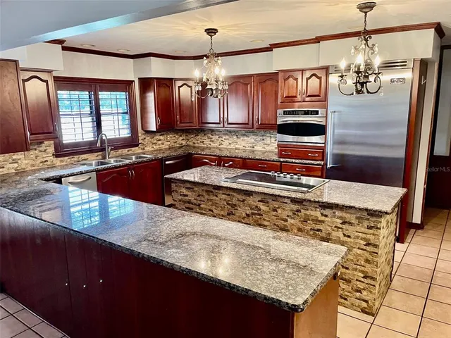 a kitchen with sink and refrigerator