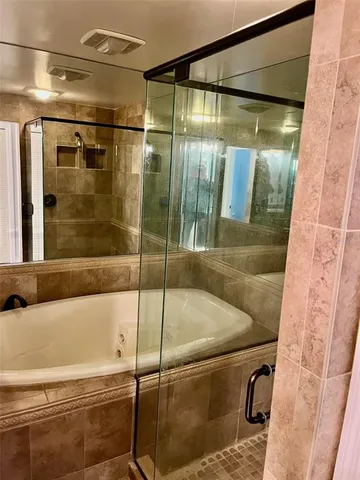 a bathroom with a glass shower door