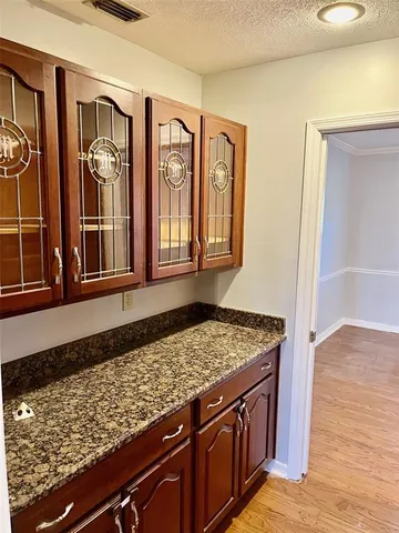 a view of a sink and dishwasher with wooden floor