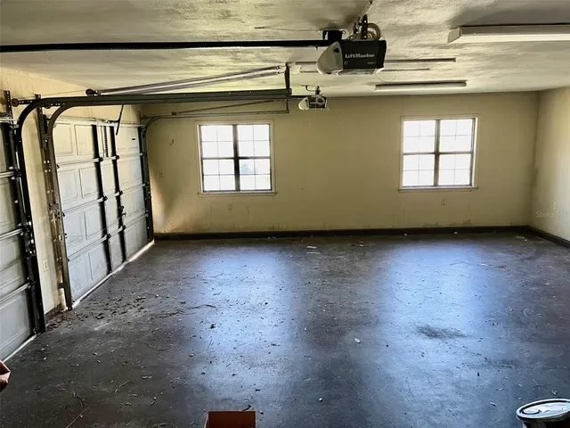 a view of a livingroom with wooden floor and windows