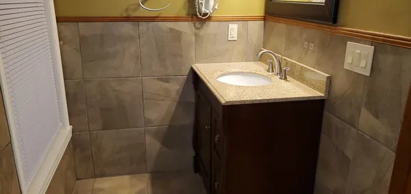 a picture of a bathroom with a shower