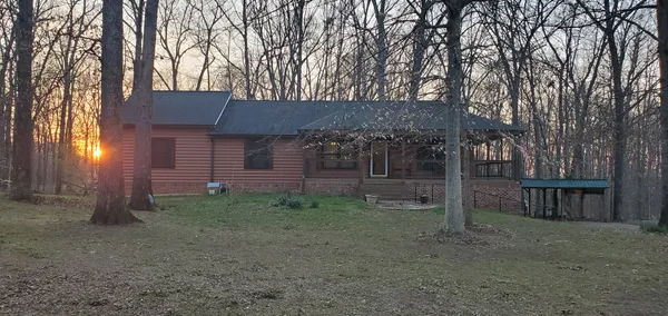 a view of a house with a backyard