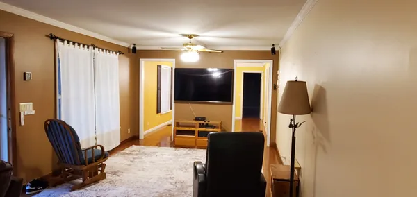 a living room with furniture and a flat screen tv