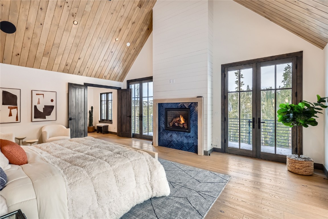 207 Barton Ridge Drive Breckenridge, CO 80424 - Photo 22 of 50 a bedroom with a bed and a fireplace