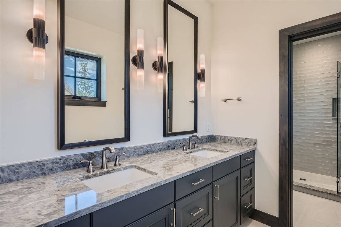 207 Barton Ridge Drive Breckenridge, CO 80424 - Photo 27 of 50 a bathroom with a granite countertop sink and a mirror
