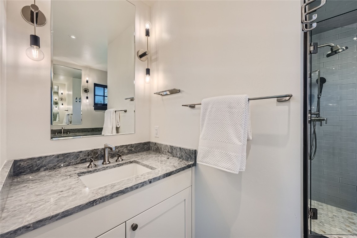 207 Barton Ridge Drive Breckenridge, CO 80424 - Photo 41 of 50 a bathroom with a granite countertop sink and a mirror