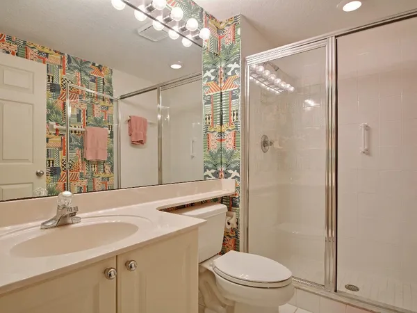a bathroom with a sink vanity mirror and toilet