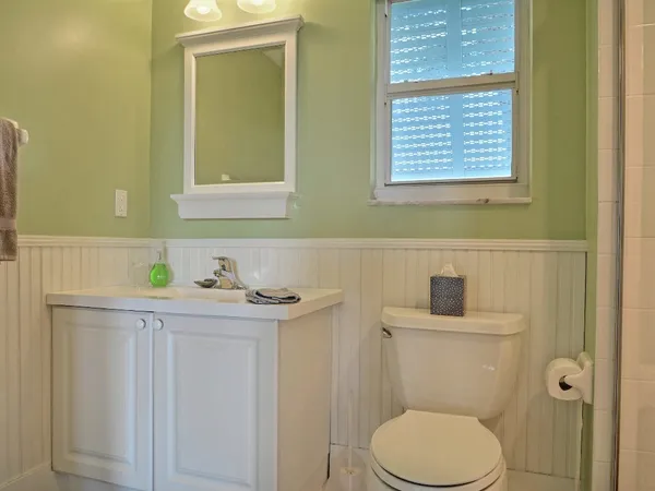 a bathroom with a toilet a sink and a window