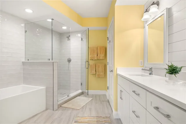 a bathroom with a sink and a mirror with bathtub