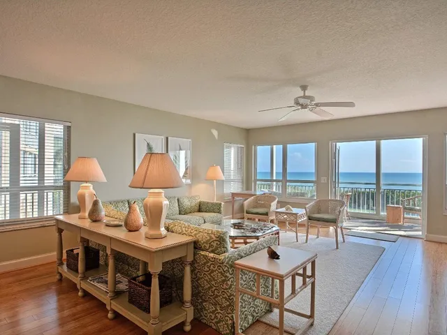 a living room with furniture a table and wooden floor