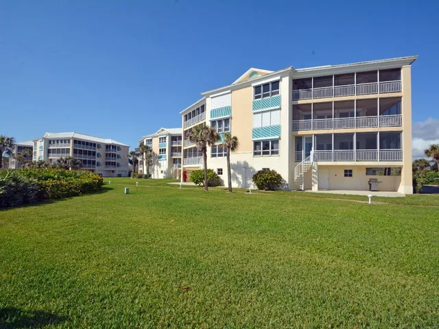 a front view of a house with a yard and outdoor seating