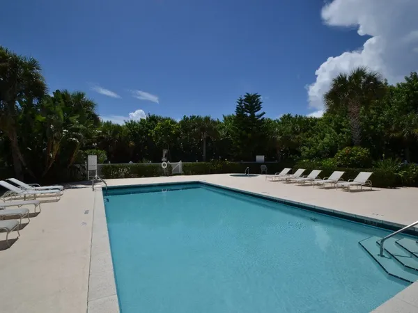 a view of a house with pool porch and sitting area