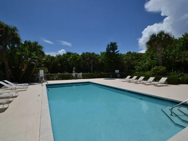 a view of a house with pool porch and sitting area