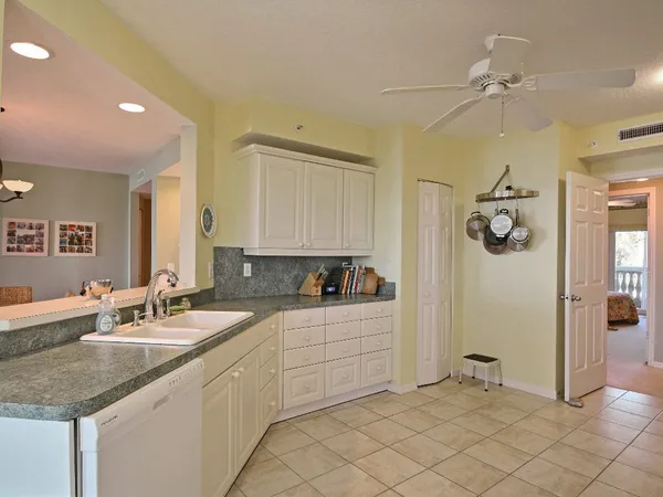a bathroom with a granite countertop sink mirror and cabinets