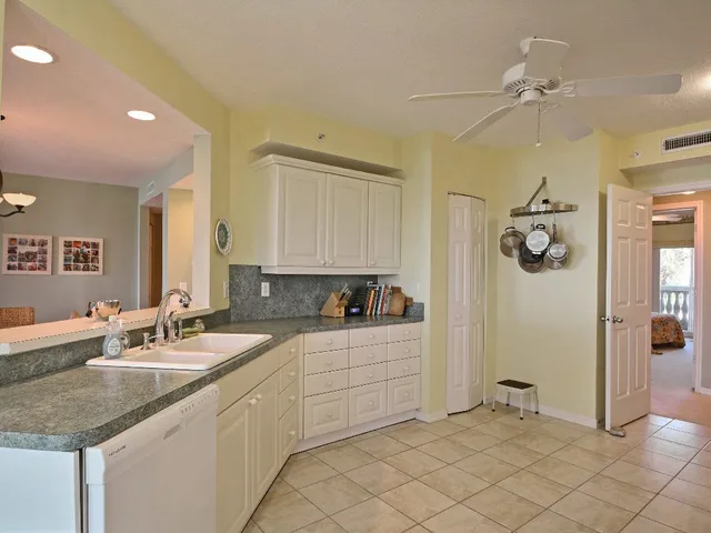 a bathroom with a granite countertop sink mirror and cabinets