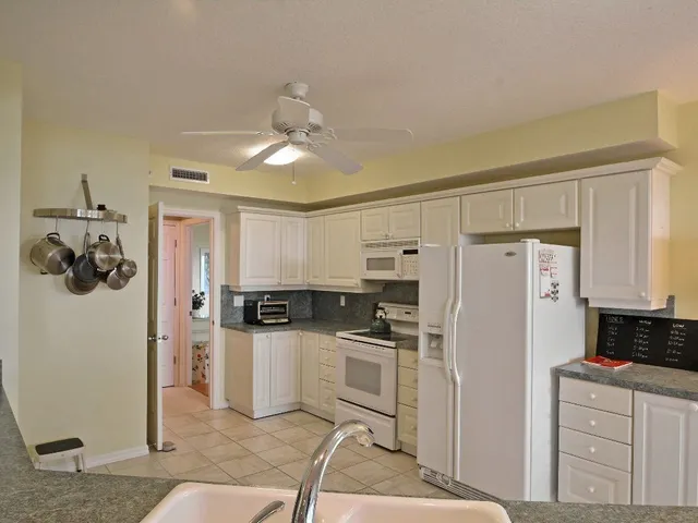a kitchen with stainless steel appliances a refrigerator sink and cabinets