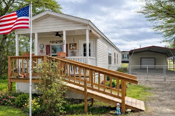 a view of a house with a yard and balcony