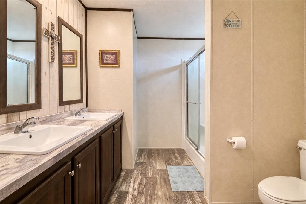 750 Waterfront Row Quitman, TX 75783 - Photo 17 of 32 a bathroom with a granite countertop sink and a mirror