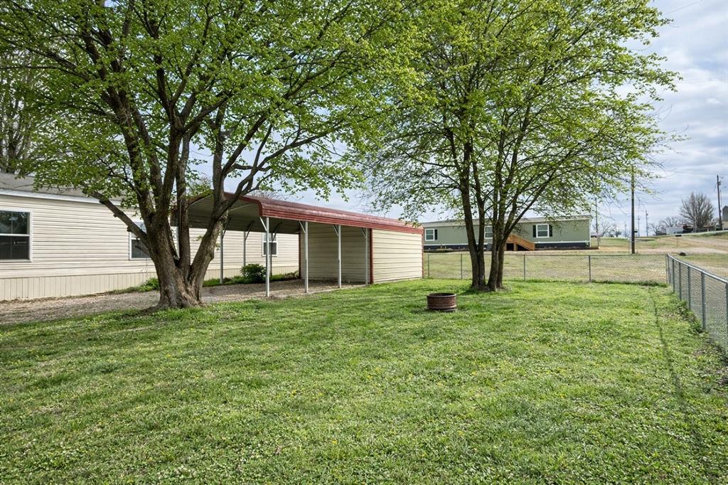 750 Waterfront Row Quitman, TX 75783 - Photo 2 of 32 a view of a yard with a house in the background