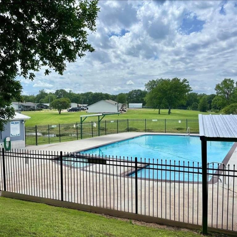 750 Waterfront Row Quitman, TX 75783 - Photo 24 of 32 a view of a yard and deck with large trees