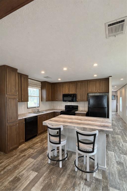 750 Waterfront Row Quitman, TX 75783 - Photo 9 of 32 a kitchen with kitchen island a sink table and chairs