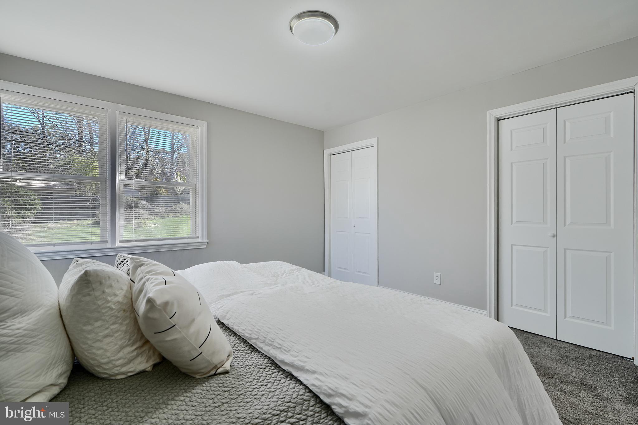 5805 Key Avenue Baltimore, MD 21215 - Photo 20 of 39 a bedroom with a bed and glass window