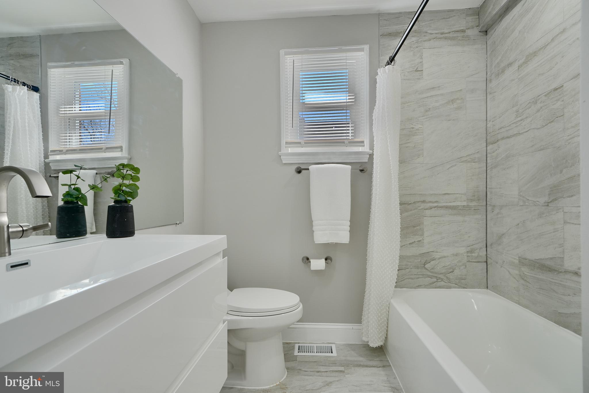 5805 Key Avenue Baltimore, MD 21215 - Photo 25 of 39 a bathroom with a sink a toilet and shower