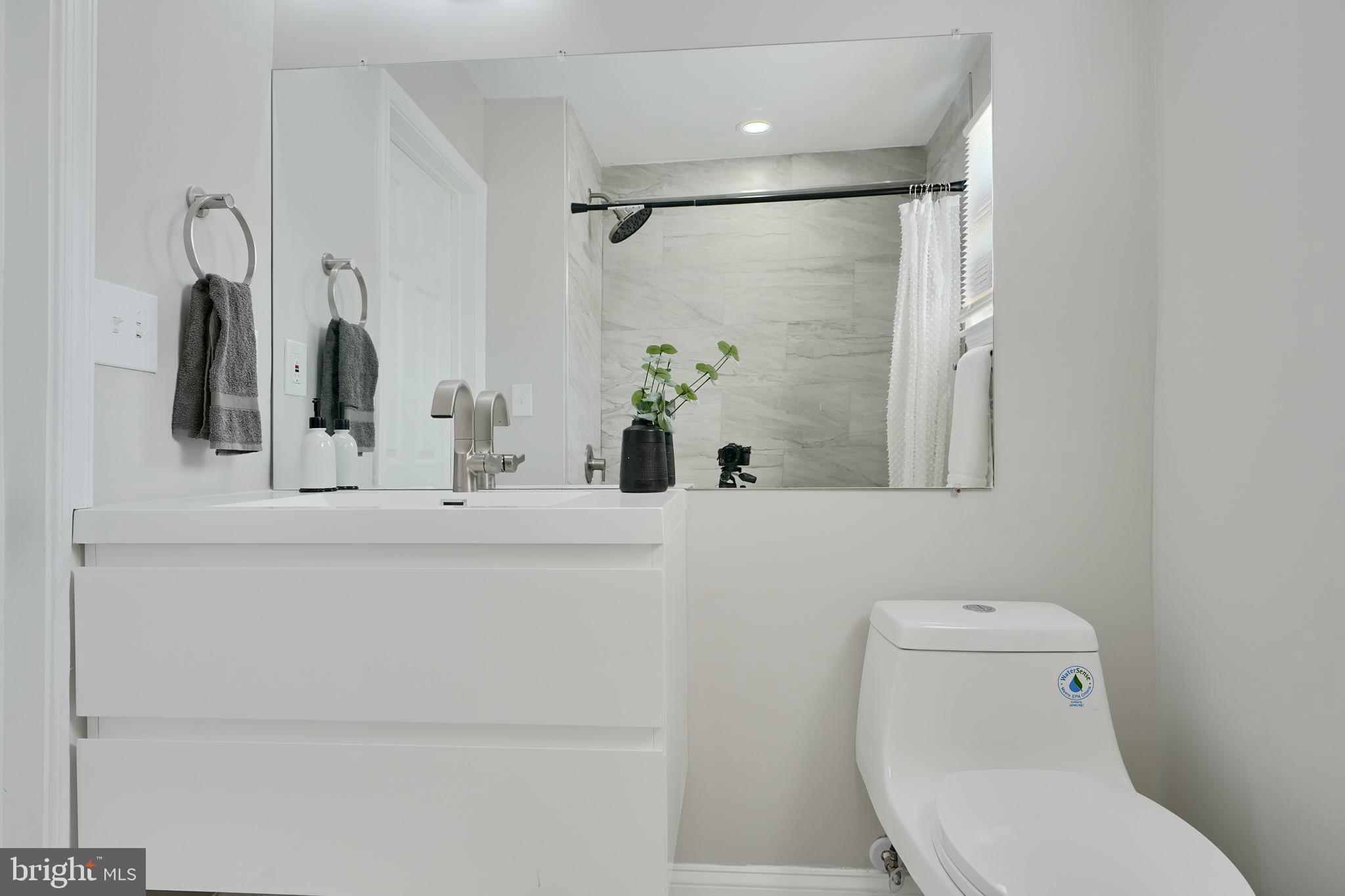 5805 Key Avenue Baltimore, MD 21215 - Photo 27 of 39 a bathroom with a sink a toilet and shower