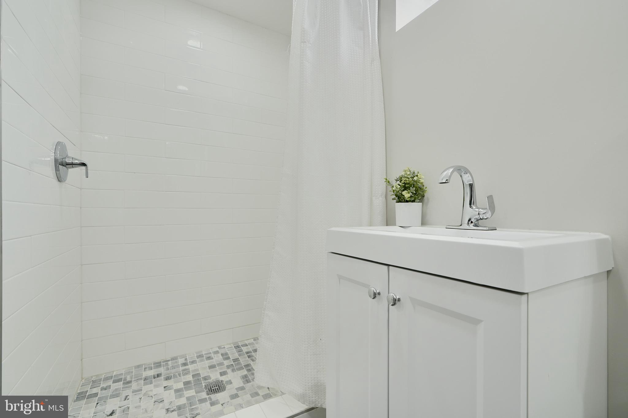 5805 Key Avenue Baltimore, MD 21215 - Photo 34 of 39 a bathroom with a sink and a mirror