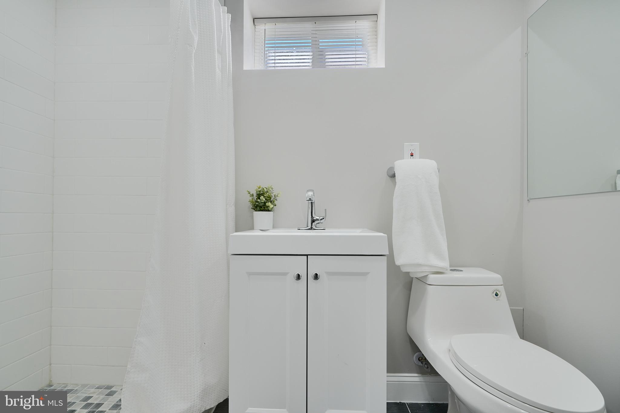5805 Key Avenue Baltimore, MD 21215 - Photo 36 of 39 a white toilet sitting next to a bathroom sink