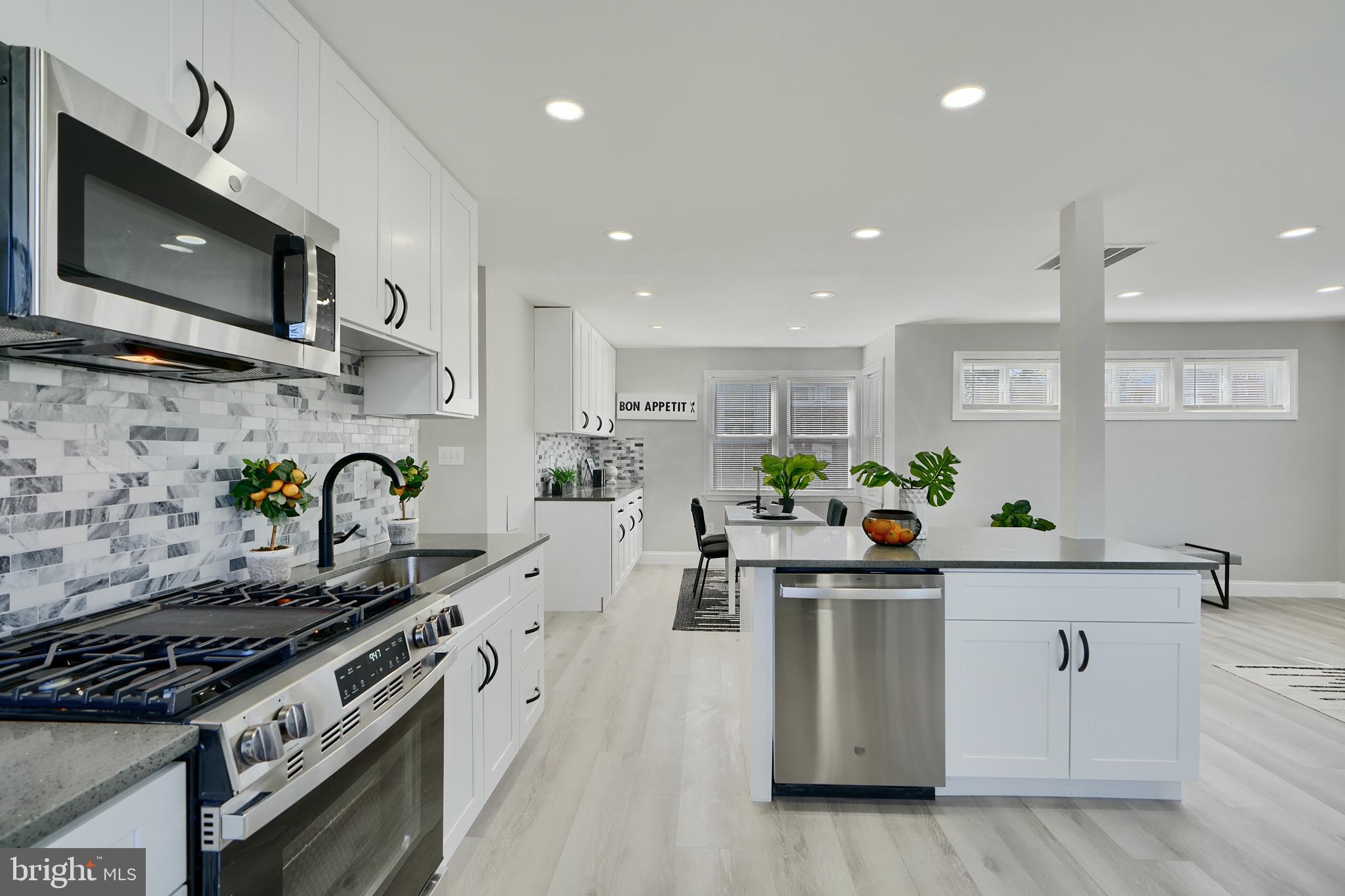 5805 Key Avenue Baltimore, MD 21215 - Photo 9 of 39 a kitchen with stainless steel appliances a sink a stove top oven a counter space and cabinets