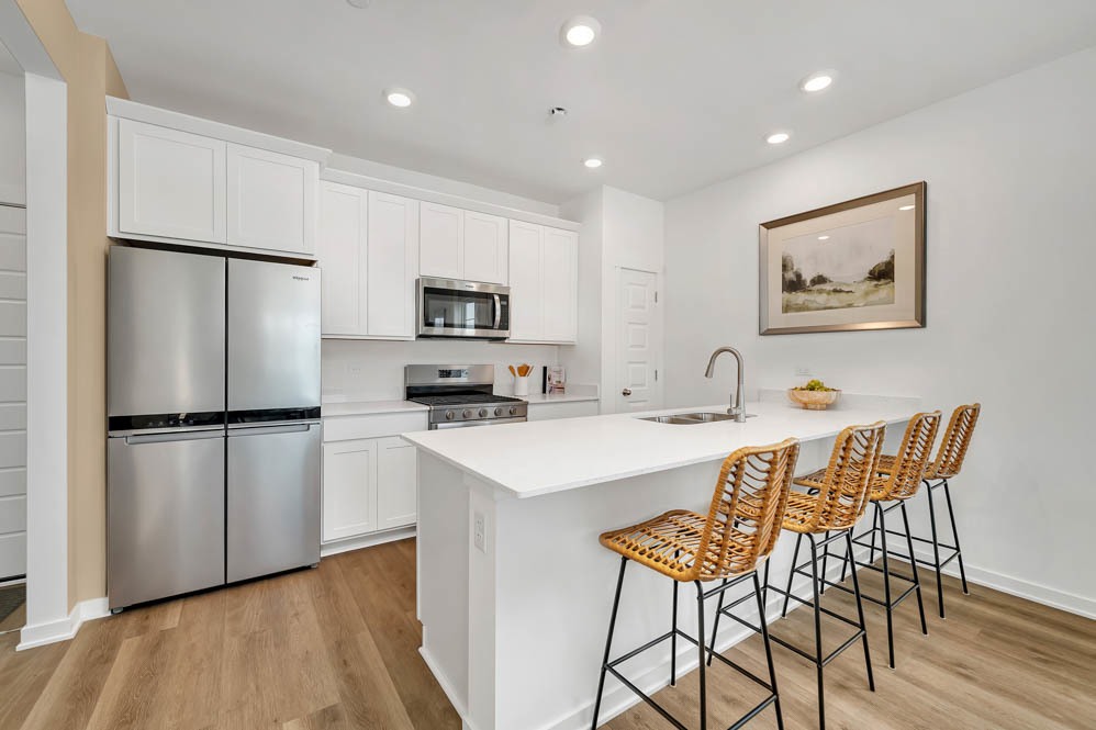 2268 Barbera Road Oswego, IL 60543 - Photo 8 of 23 a kitchen with stainless steel appliances a refrigerator a stove a sink a dining table and chairs