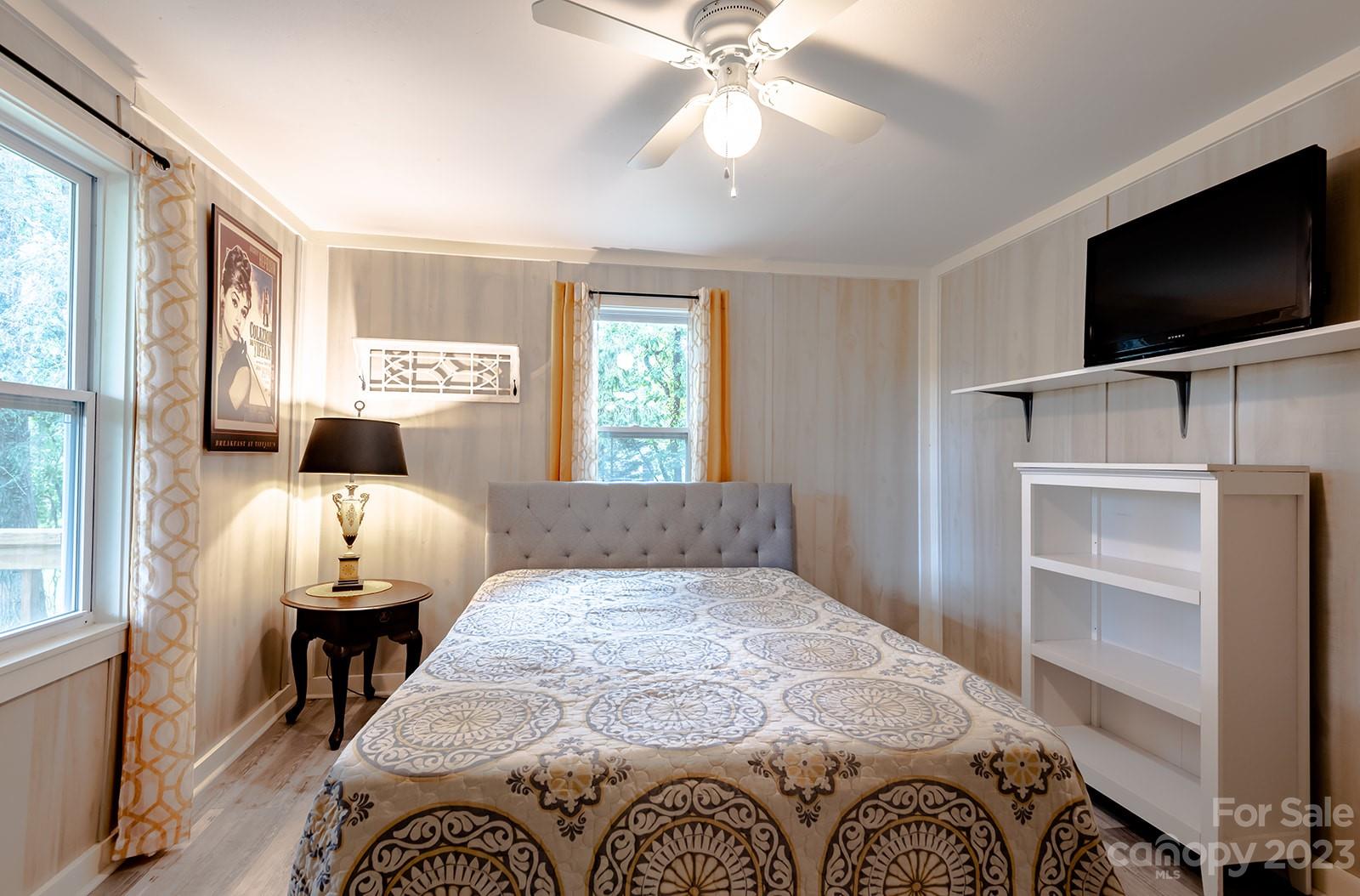 653 Sand Hill Road Asheville, NC 28806 - Photo 14 of 27 a bedroom with a bed and flat screen tv