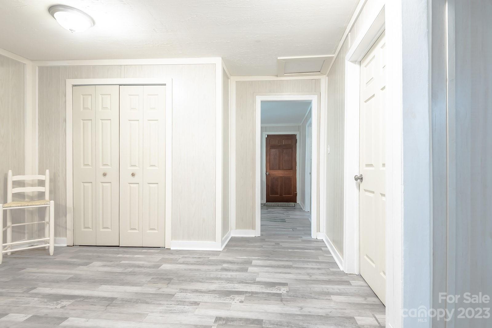 653 Sand Hill Road Asheville, NC 28806 - Photo 15 of 27 a view of a hallway with wooden floor and closet area