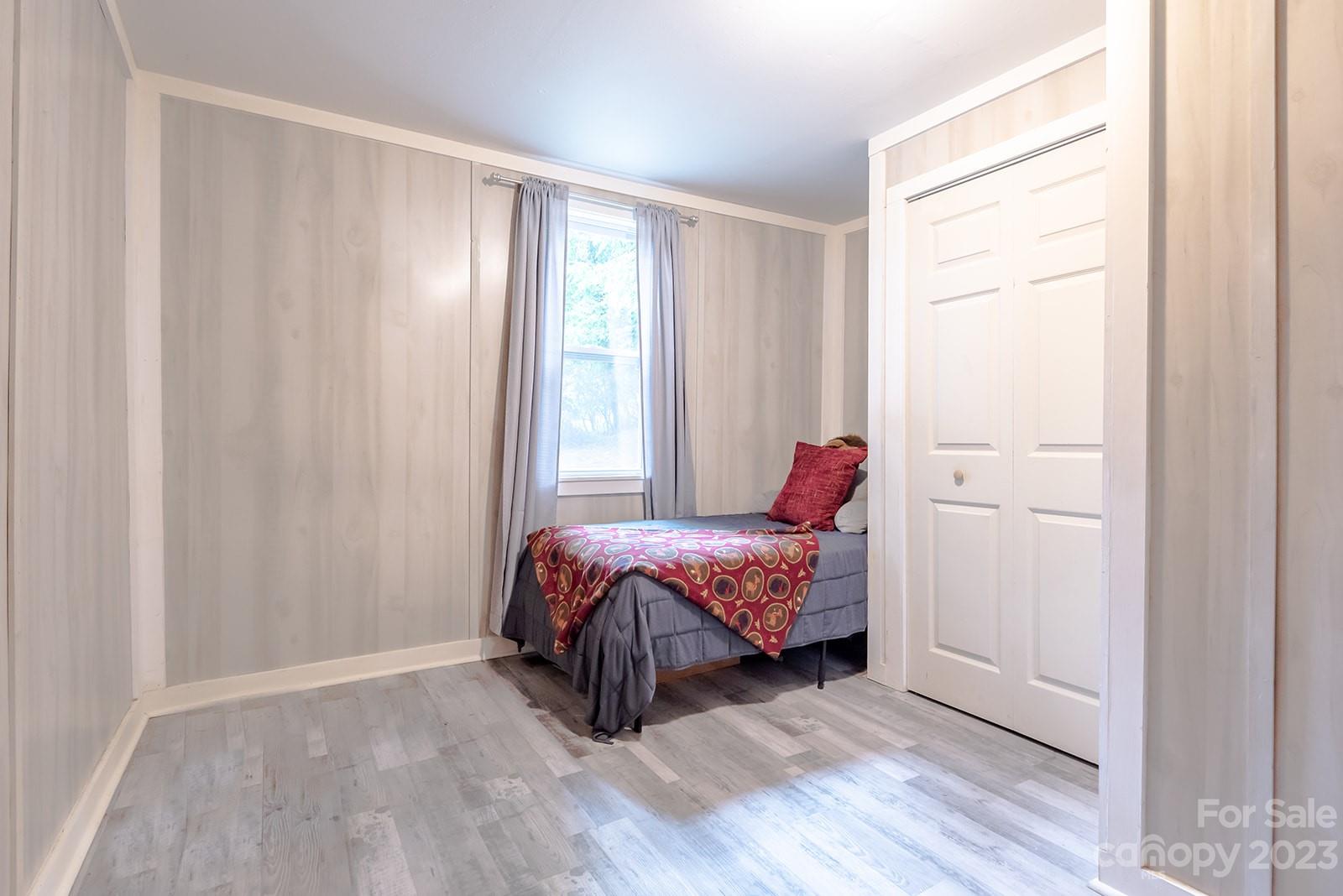 653 Sand Hill Road Asheville, NC 28806 - Photo 17 of 27 a bedroom with a bed and a window