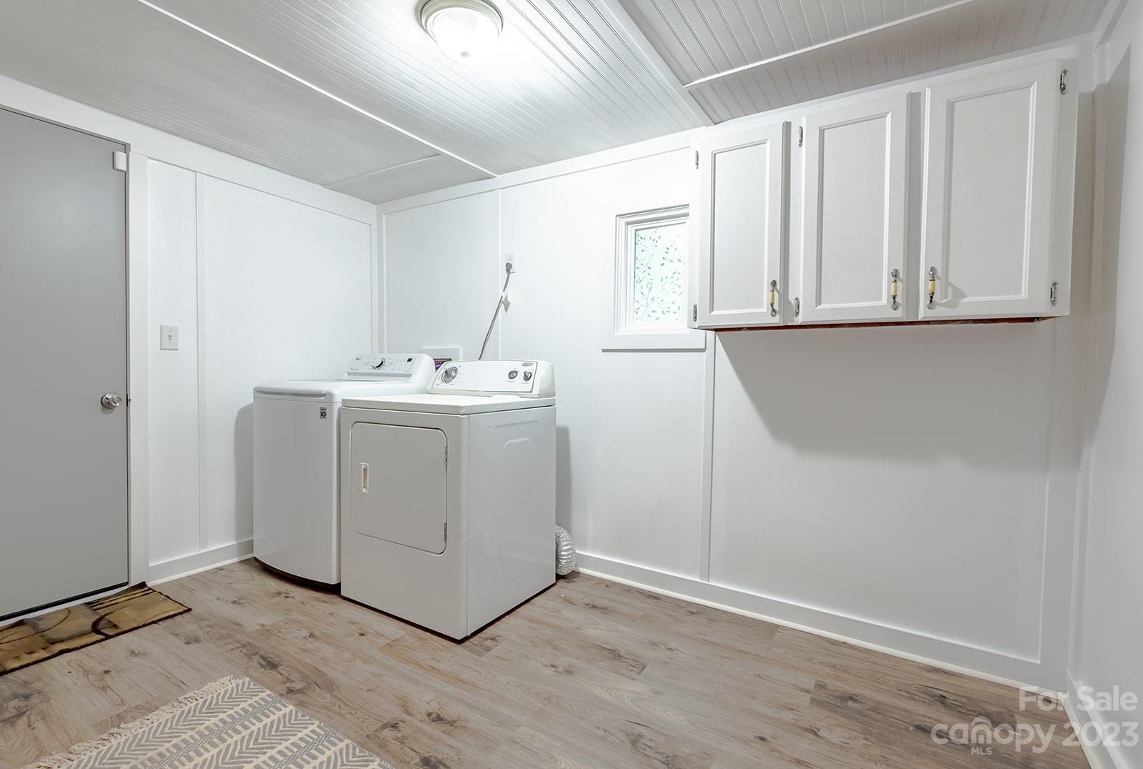 653 Sand Hill Road Asheville, NC 28806 - Photo 18 of 27 a utility room with cabinets washer and dryer