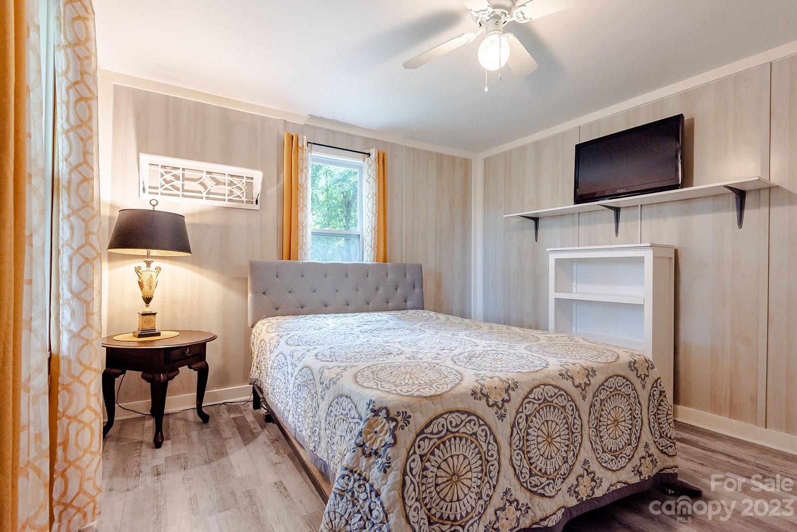653 Sand Hill Road Asheville, NC 28806 - Photo 22 of 27 a bedroom with a bed and a flat screen tv
