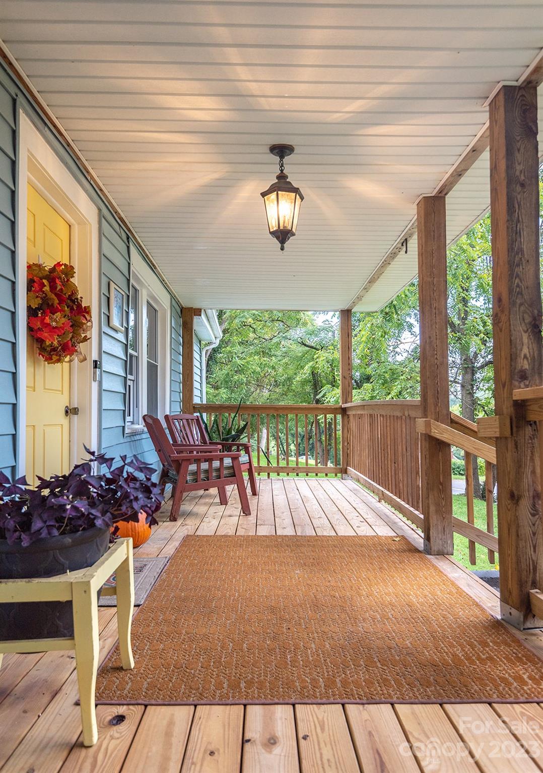 653 Sand Hill Road Asheville, NC 28806 - Photo 3 of 27 a view of a patio with table and chairs potted plants with wooden floor