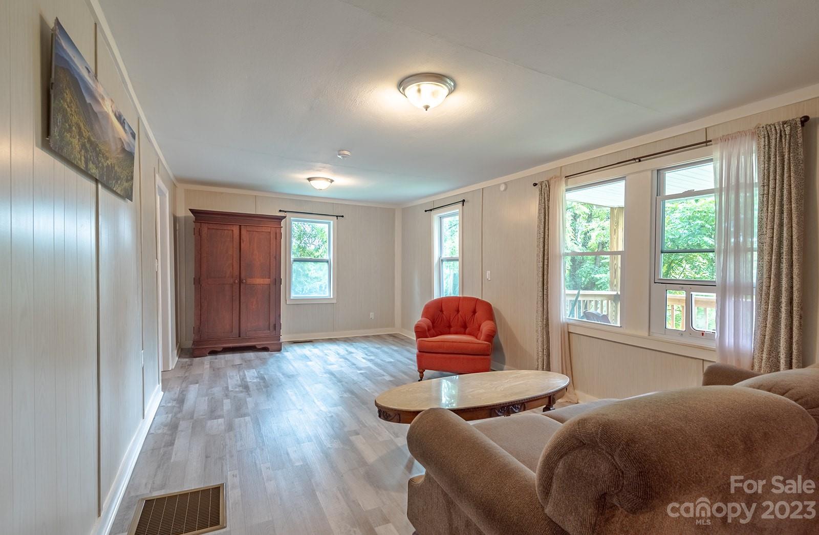 653 Sand Hill Road Asheville, NC 28806 - Photo 6 of 27 a bedroom with a bed and wooden floor