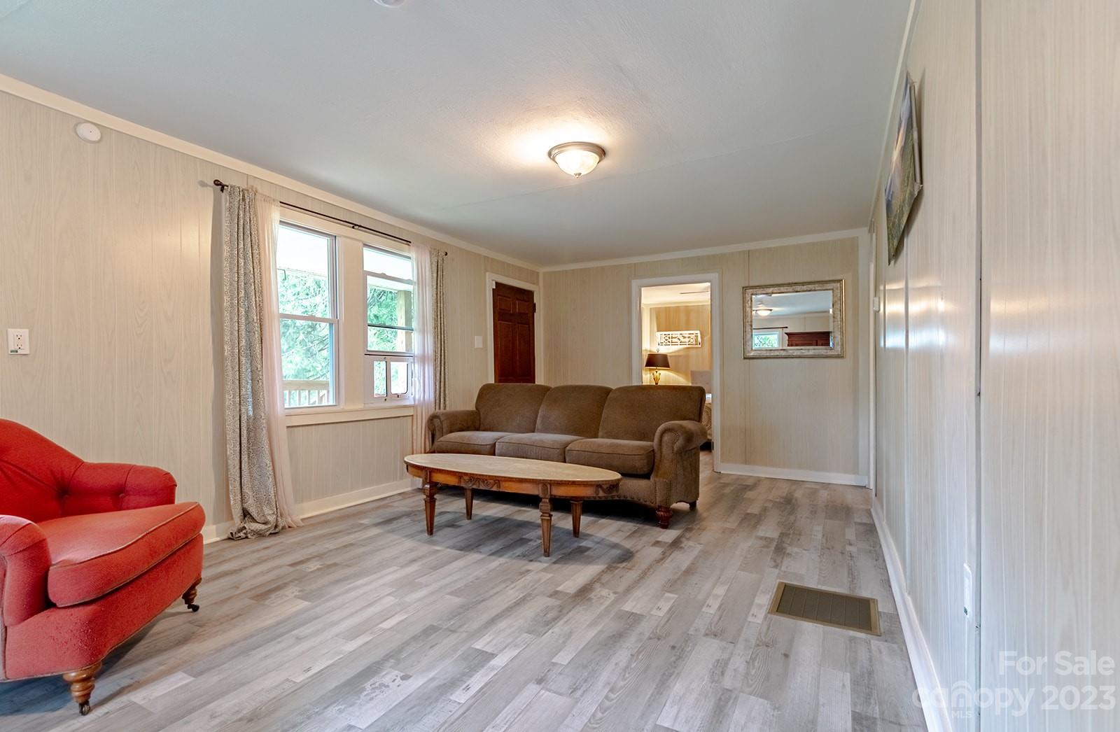 653 Sand Hill Road Asheville, NC 28806 - Photo 7 of 27 a living room with furniture and a wooden floor