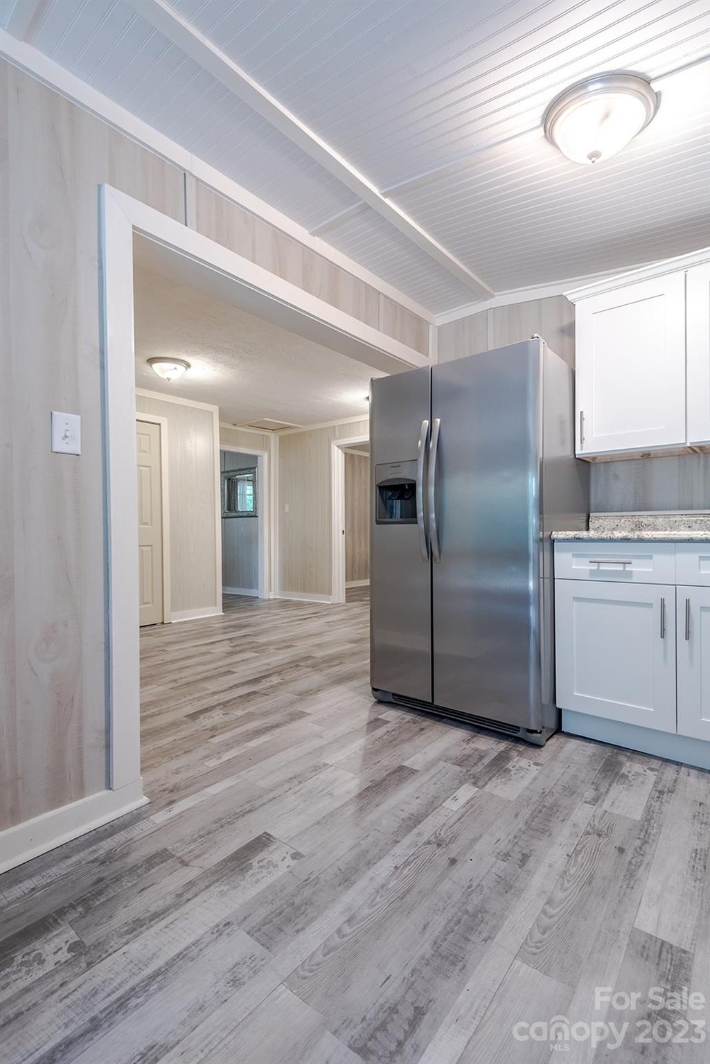 653 Sand Hill Road Asheville, NC 28806 - Photo 8 of 27 a view of a kitchen center wooden floor and electronic appliances