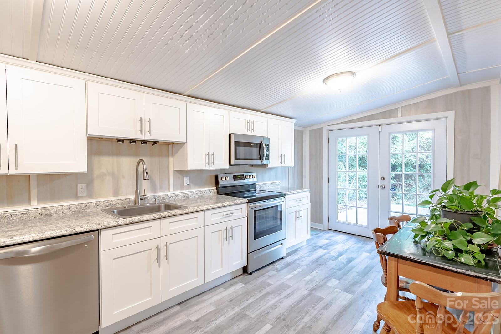 653 Sand Hill Road Asheville, NC 28806 - Photo 10 of 27 a kitchen with a sink stove top oven and refrigerator
