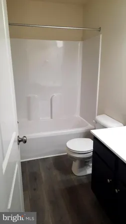 a bathroom with a toilet a sink and bathtub