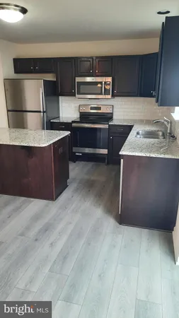 a kitchen with kitchen island cabinets and oven