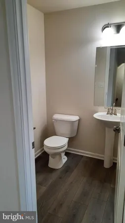 a white toilet sitting next to a bathroom sink