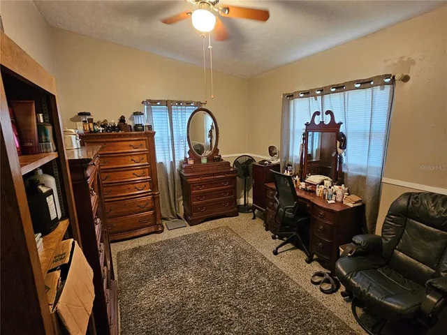 a bed room with a bed and a television