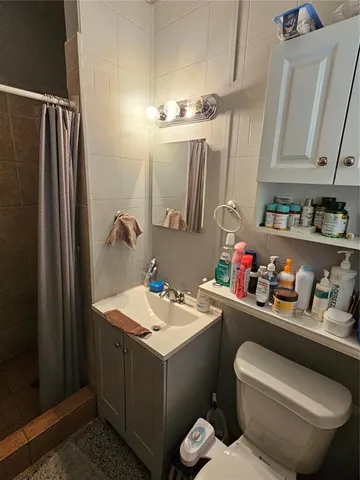 a bathroom with a sink toilet vanity and tub
