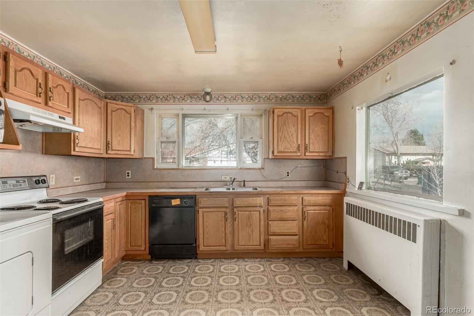 10480 West 47th Avenue Wheat Ridge, CO 80033 - Photo 13 of 29 a kitchen with a sink stove and cabinets