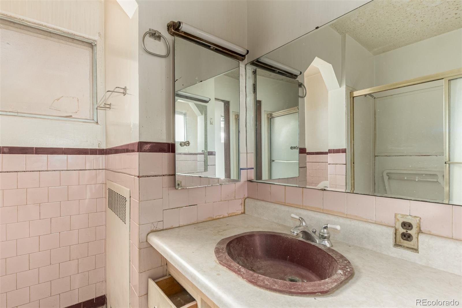 10480 West 47th Avenue Wheat Ridge, CO 80033 - Photo 19 of 29 a bathroom with a sink a toilet and shower