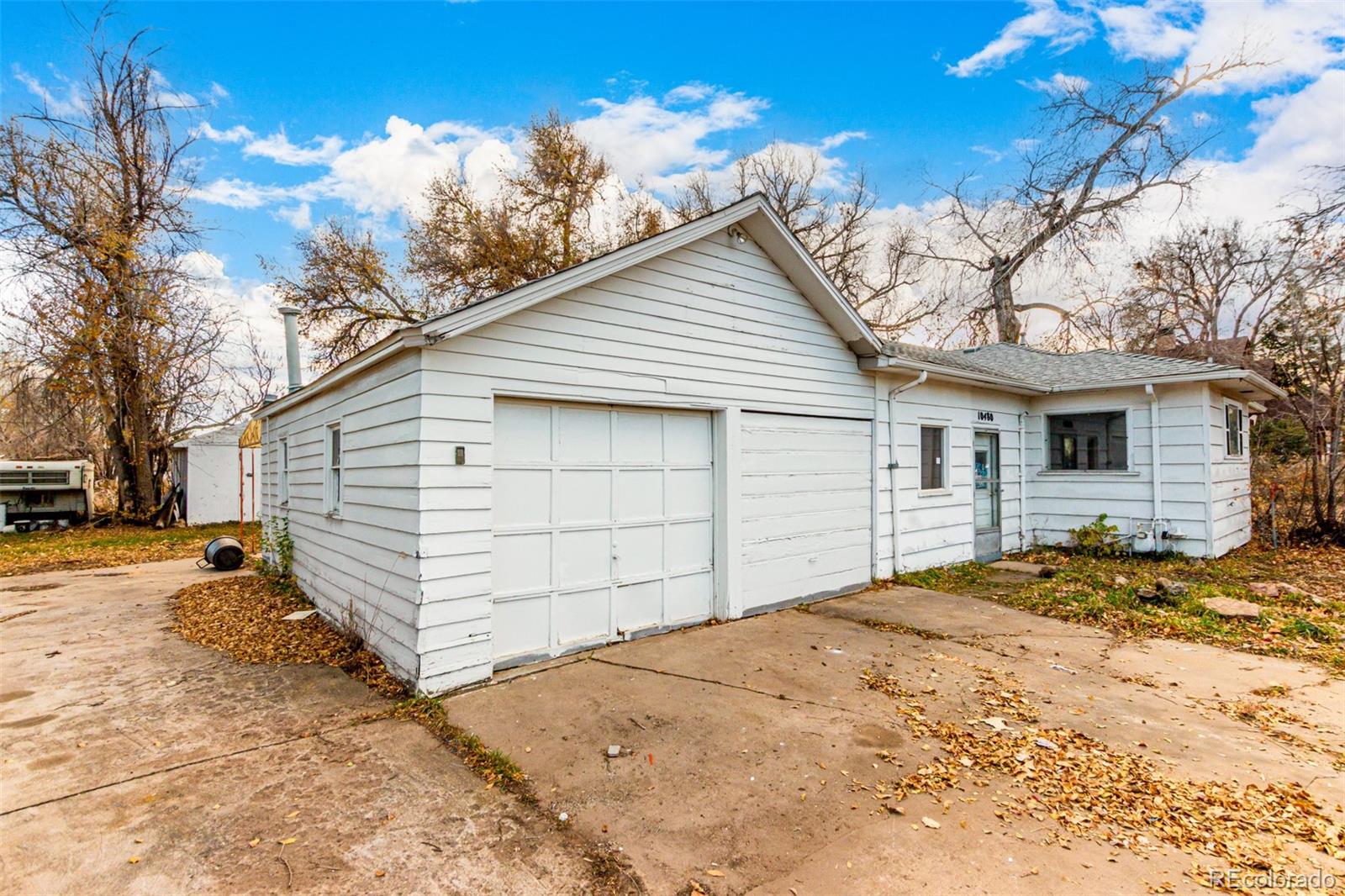 10480 West 47th Avenue Wheat Ridge, CO 80033 - Photo 2 of 29 a view of a backyard with a large tree